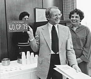 Dr. Kennedy holds up a commemorative license plate at his retirement celebration in 1979.