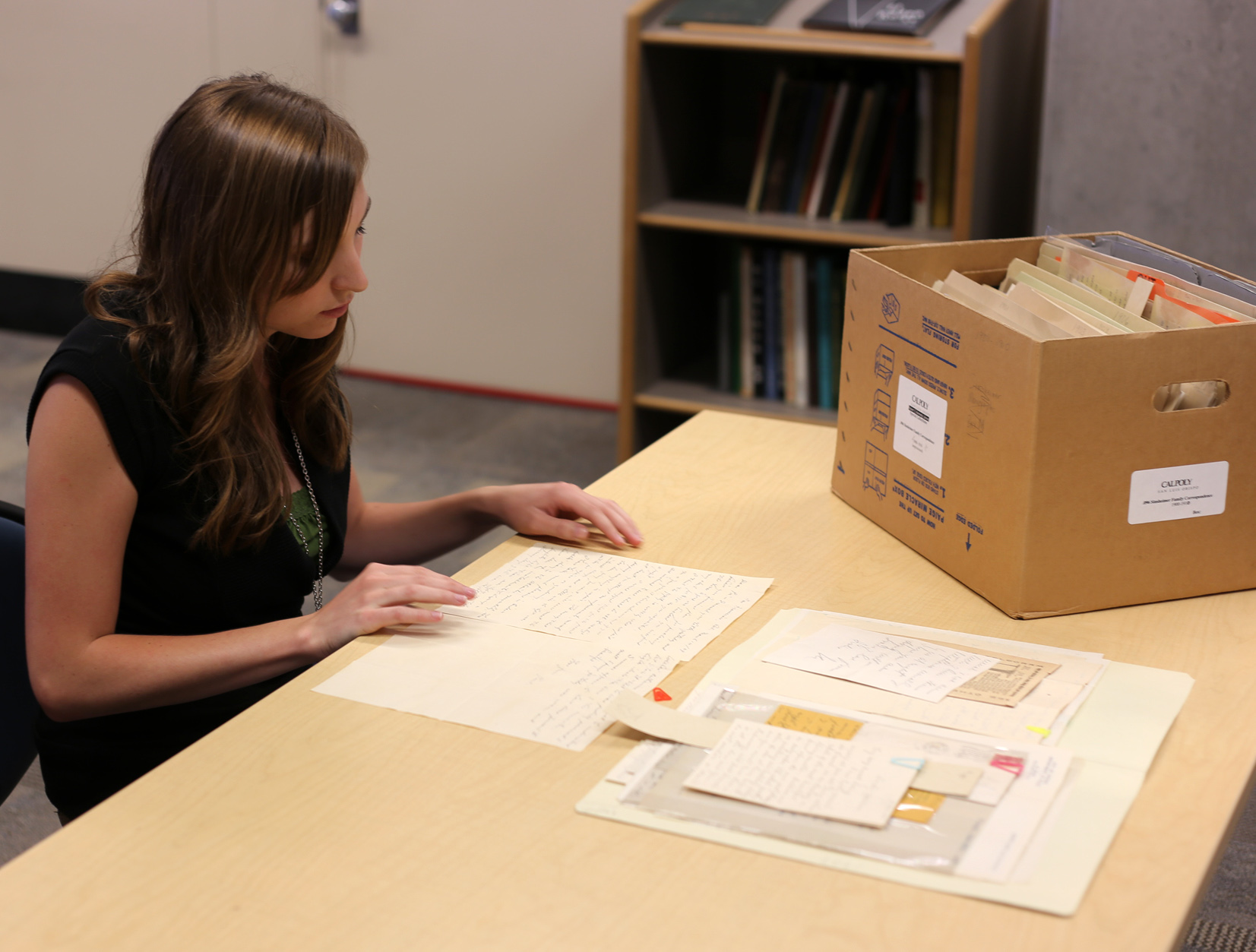 Wendy looking through a folder of correspondence in the Sinsheimer Family Correspondence