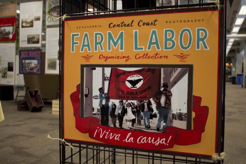 A photo of an exhibit poster that says "Farm Labor" with a photo of farm laborers uniting.