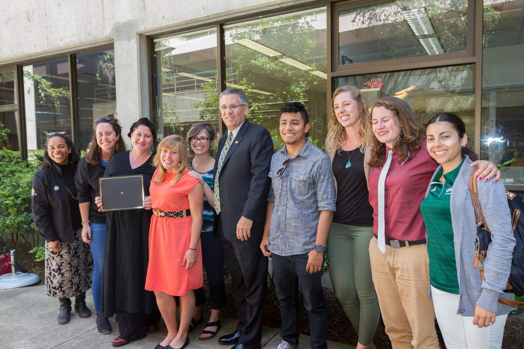 President Armstrong and the diversity award winners stood and smiled together in the library atrium.